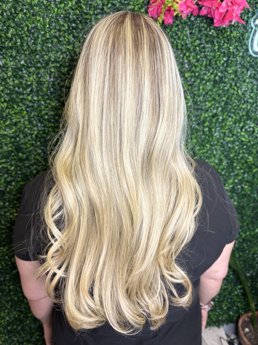Long platinum blonde hair with soft waves, seen from behind